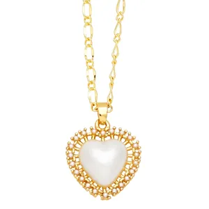 Golden Figaro chain necklace featuring a heart-shaped pearl pendant with a textured border
