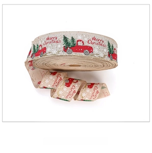 Detailed texture of burlap Christmas ribbon with red truck and festive tree print