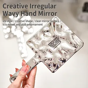 Creative wavy silver handheld makeup mirror with an irregular metallic rippled design
