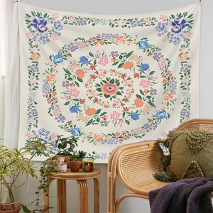 Floral mandala tapestry in a boho room setting with vibrant pink and orange tones