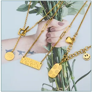 Detail of 18k gold plated jewelry set featuring celtic knots and smiley face pendants