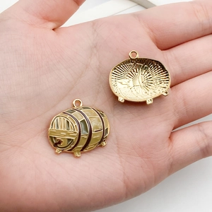 Macro detail of wine barrel enamel charms in gold finish for DIY jewelry making