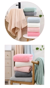 Close-up of thick coral fleece towels with pineapple texture in various soft colors