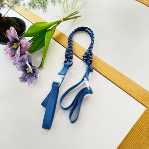 Detailed view of durable blue nylon woven strap with a white plastic buckle for tote bags