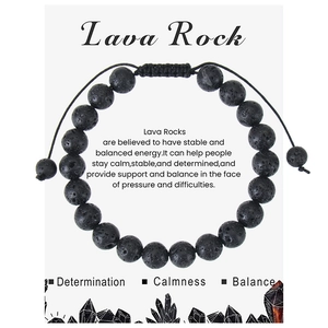 Detailed macro view of black volcanic lava rock beads on adjustable woven rope bracelet