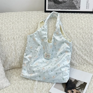Detail of light blue crushed velvet tote featuring bear prints and sozakka beauté label