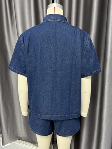 Rear view of dark blue denim set showing orange contrast stitching and loose fit cut