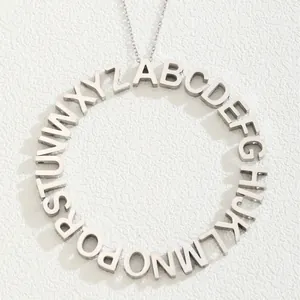 Minimalist silver stainless steel round pendant necklace featuring 26 capital letters