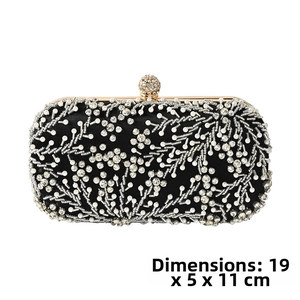 Detail showing pearl and rhinestone floral embroidery on a black satin evening clutch bag