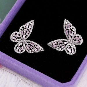 Detailed view of silver butterfly earrings with pink cubic zirconia in a jewelry box