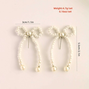 Detailed view of pearl bow earrings with size 3x5.5cm and weight 4.7g specifications