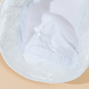 Detailed macro view of the white sun hat interior with adjustable drawstring and texture