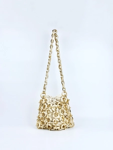 Detail view of cream acrylic bucket bag with hexagonal resin mesh and gold drawstring