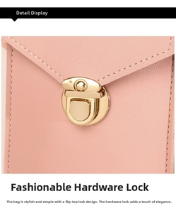 Close-up of pink leather crossbody bag showing golden circular hardware buckle and neat stitching