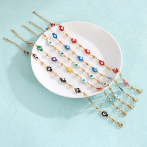 Hamsa Hand and Evil Eye bracelets in five colors on a white plate with golden finish