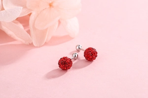 Macro view of a pair of red crystal ball stud earrings with S925 silver screw backings