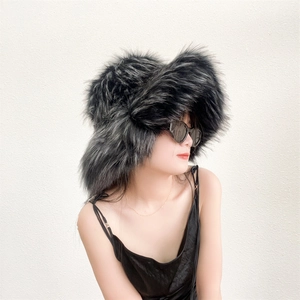 Close-up of thick faux raccoon fur hat in black and grey for stylish winter warmth