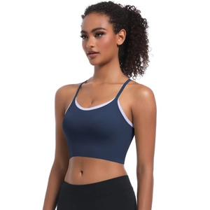 Detailed view of dark blue sports bra with white trim showing straps and fit