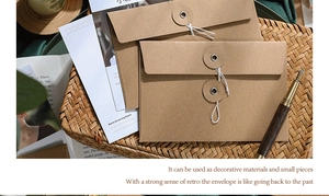 Retro brown kraft paper envelopes with classic string and button tie closure detail