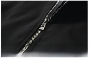 Macro shot of silver metal zipper detail on black fashionable bomber jacket for men