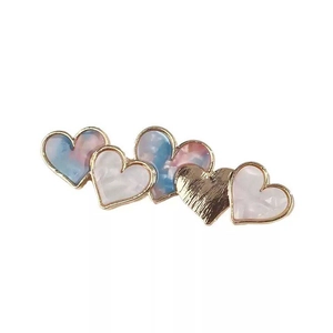 Elegant heart-shaped acetate hair clip with marble patterns and gold metal borders