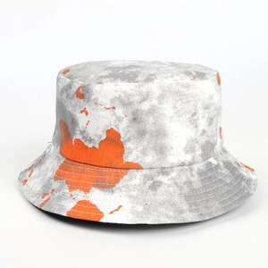 Close-up of tie-dye bucket hat featuring orange ink splash pattern and reinforced stitching