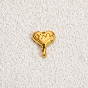 Golden fluid heart pendant with molten metal texture on minimalist textured background