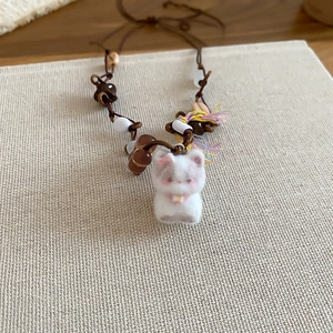 Detailed view of handmade vintage cat pendant necklace with cat wool felt and beads