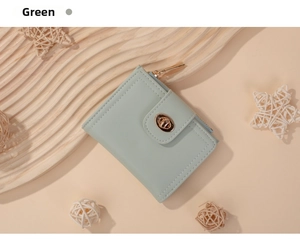 Detail of mint green PU leather wallet with gold twist-lock and smooth zipper closure
