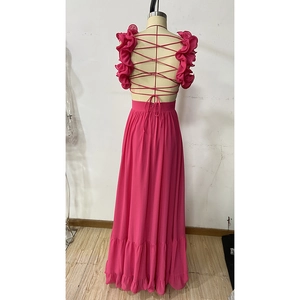 Détail de la robe de soirée en mousseline rose avec dos nu à lacets et volants