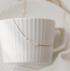 Minimalist gold titanium steel necklace featuring eight elegant small pearls for women