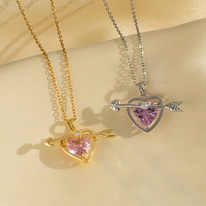 Pink heart pendant necklace with arrow design in gold and silver finishes on satin