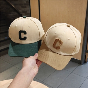 Close-up of color-block baseball caps with large C embroidery and premium cotton texture