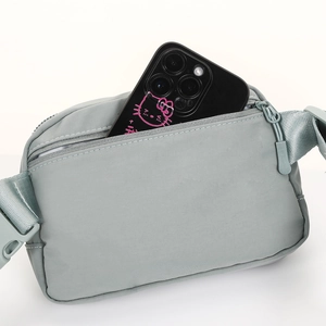 Light blue multipurpose nylon waist bag showing rear zipper pocket with smartphone storage