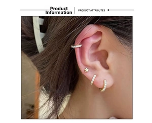 Close-up of gold flower stud and sparkling zircon hoops worn on ear for minimalist style