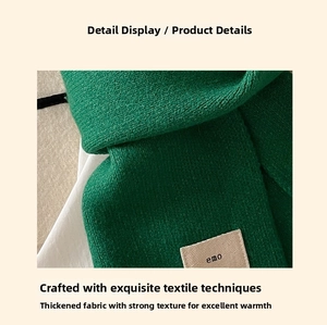 Close-up of green knit scarf showing thick twill texture and white emo woven label