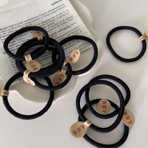 Seamless high elasticity black hair ties on a ceramic tray for ponytails