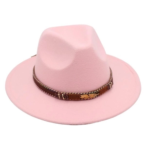 Detail of pink fedora hat with brown woven band and golden metal feather charm