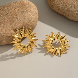 Polished gold sunburst geometric stud earrings in stainless steel on natural stones