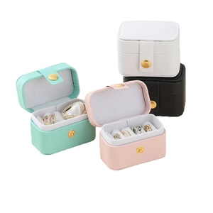 Portable leather jewelry box in mint green, pink, white, and black with zipper closure