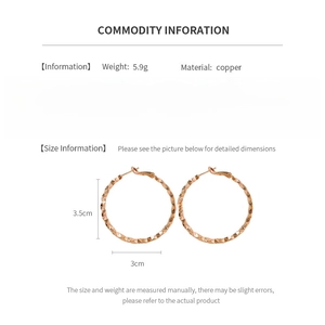 Detail view of irregular textured gold hoop earrings with size 3cm and copper material info