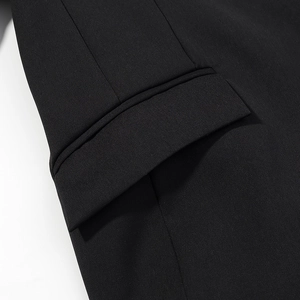 Detailed macro view of high-quality black twill fabric and pocket flap craftsmanship