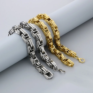 Detail of silver and gold Byzantine chain necklaces with secure lobster clasps on a pedestal
