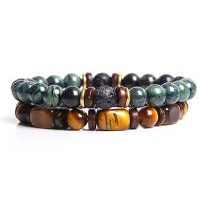 Detail view of tiger eye beads and volcanic stone bracelet set on white background