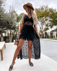 Detail of black lace cutout jumpsuit with V-neckline and high-slit skirt design
