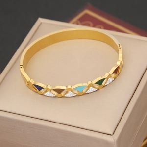Gold stainless steel bangle with colorful fan charms and crystals on jewelry box
