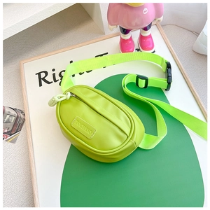 Detail of neon green PU leather kids crossbody bag with adjustable wide shoulder strap
