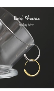 Detailed view of O-shaped 925 sterling silver earrings in gold and silver finishes