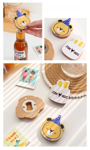 Detail of wooden animal bottle opener with magnetic back and stainless steel opener part