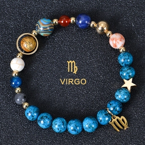 Detail of Virgo beaded bracelet with blue natural stones and golden zodiac charm